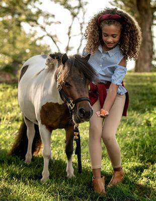 Woman Sitting by the Firepit outside Harrimans
