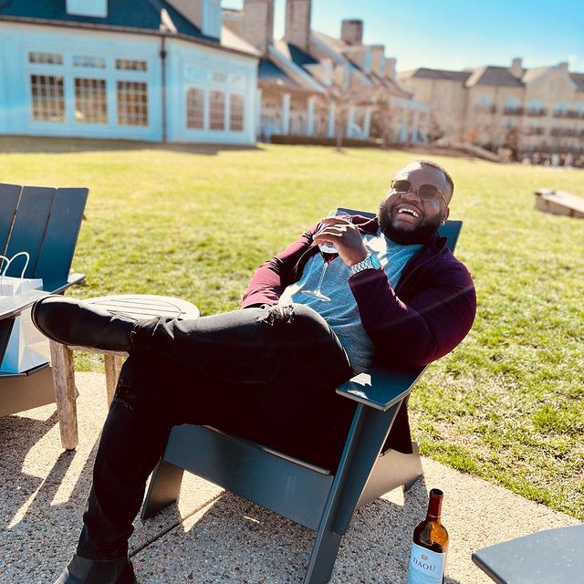 a man smiling and enjoying wine